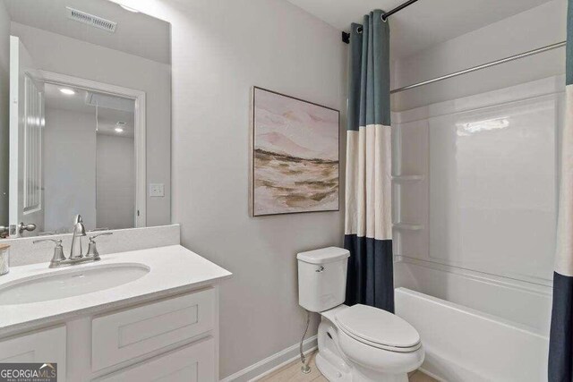 full bathroom with toilet, vanity, and shower / tub combo with curtain