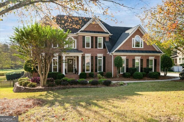 colonial-style house with a front yard