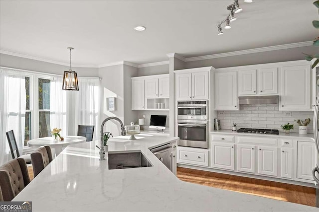 kitchen with dark wood-type flooring, sink, appliances with stainless steel finishes, light stone counters, and white cabinetry