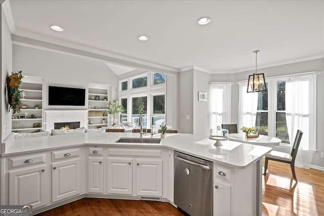 kitchen with white cabinetry, stainless steel dishwasher, and hardwood / wood-style flooring