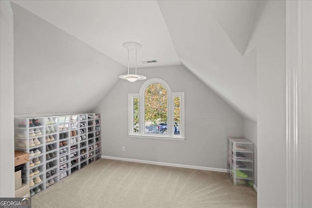 bonus room with carpet flooring and vaulted ceiling