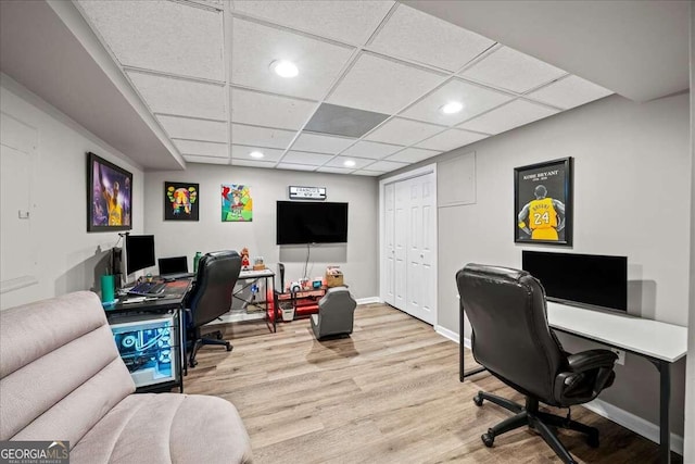 office with a paneled ceiling and light wood-type flooring