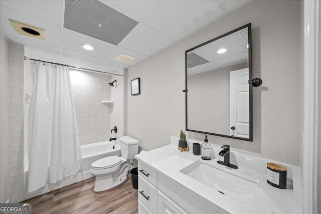 full bathroom featuring vanity, toilet, wood-type flooring, and shower / tub combo with curtain