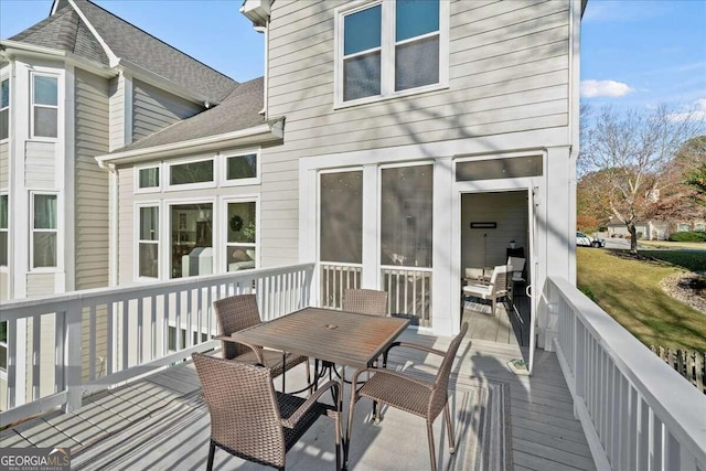 rear view of property featuring a deck