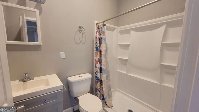 bathroom featuring a shower with curtain, vanity, and toilet