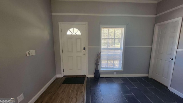 entryway featuring crown molding and dark hardwood / wood-style floors