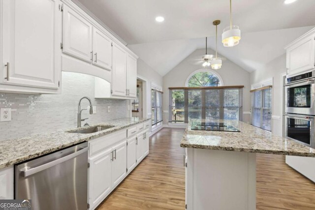 kitchen featuring stainless steel appliances, ceiling fan, sink, light hardwood / wood-style flooring, and white cabinets