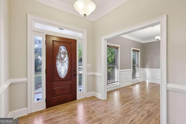 foyer featuring plenty of natural light, light hardwood / wood-style floors, and crown molding