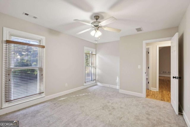 spare room with carpet flooring and ceiling fan