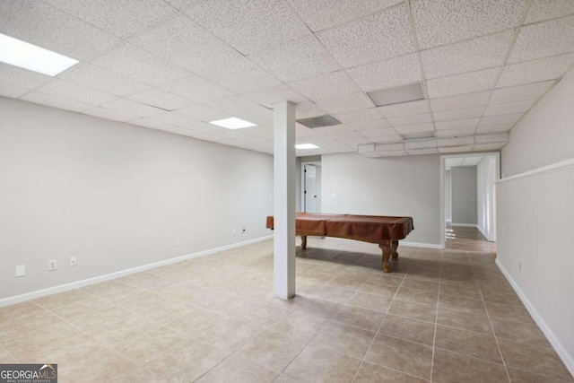 spare room featuring carpet flooring and a drop ceiling