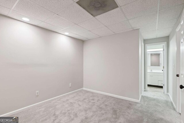 spacious closet with a drop ceiling and carpet floors