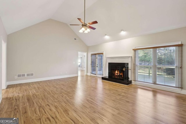 unfurnished living room featuring ceiling fan, high vaulted ceiling, and light hardwood / wood-style floors