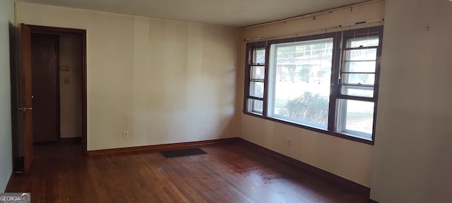 unfurnished room with dark hardwood / wood-style floors