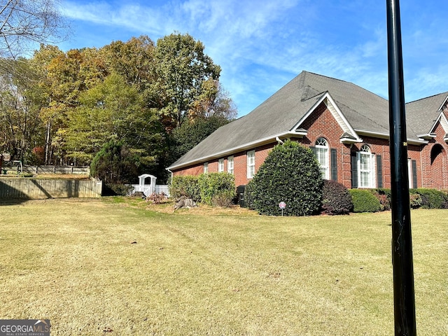 view of side of home with a lawn