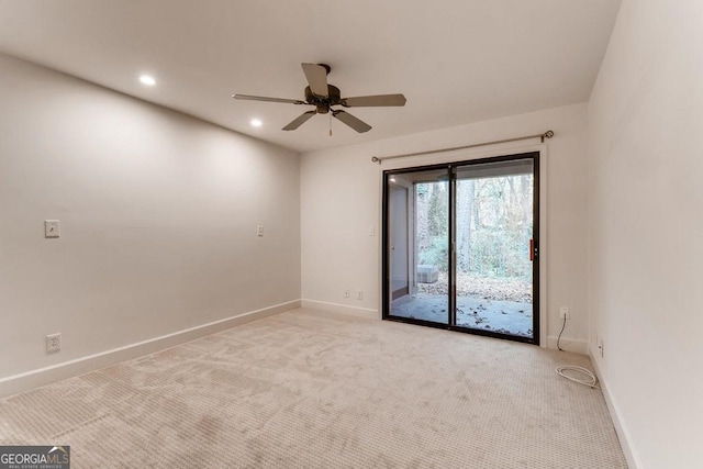 empty room with ceiling fan and light carpet