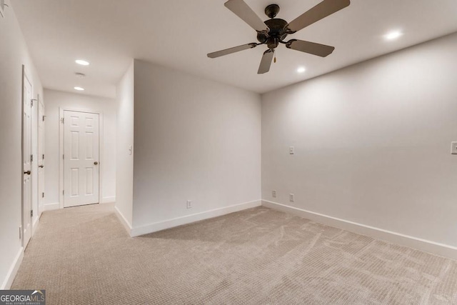 empty room featuring light carpet and ceiling fan