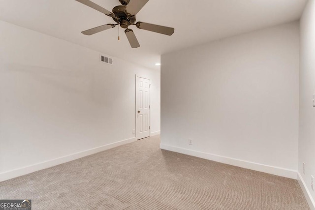 empty room with light colored carpet and ceiling fan