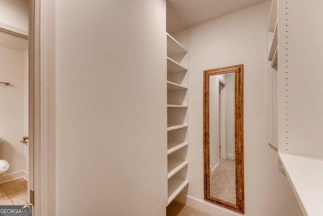 spacious closet featuring light tile patterned flooring