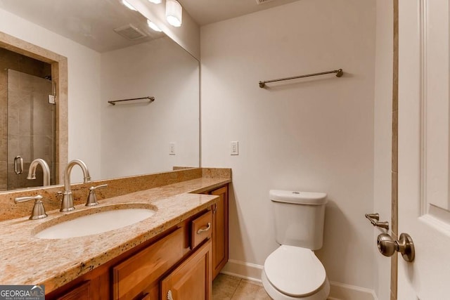 bathroom featuring tile patterned floors, a shower with door, vanity, and toilet