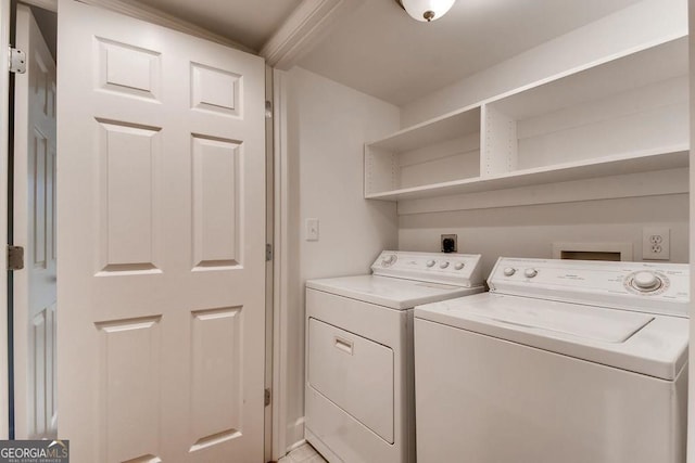 clothes washing area featuring washer and clothes dryer