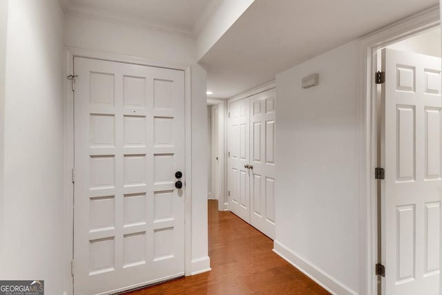 entryway with hardwood / wood-style floors and ornamental molding