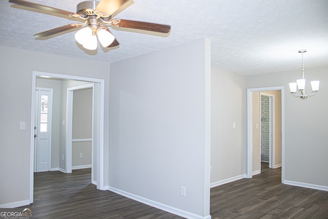 unfurnished room featuring ceiling fan with notable chandelier, a textured ceiling, and dark hardwood / wood-style flooring