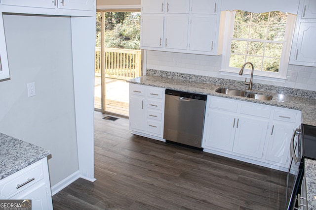 kitchen with backsplash, white cabinets, sink, dark hardwood / wood-style floors, and appliances with stainless steel finishes