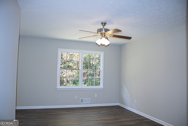 spare room with ceiling fan, dark wood-type flooring, and a textured ceiling