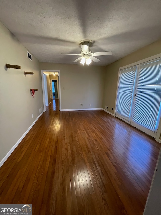 interior space with wood-type flooring, a textured ceiling, and ceiling fan