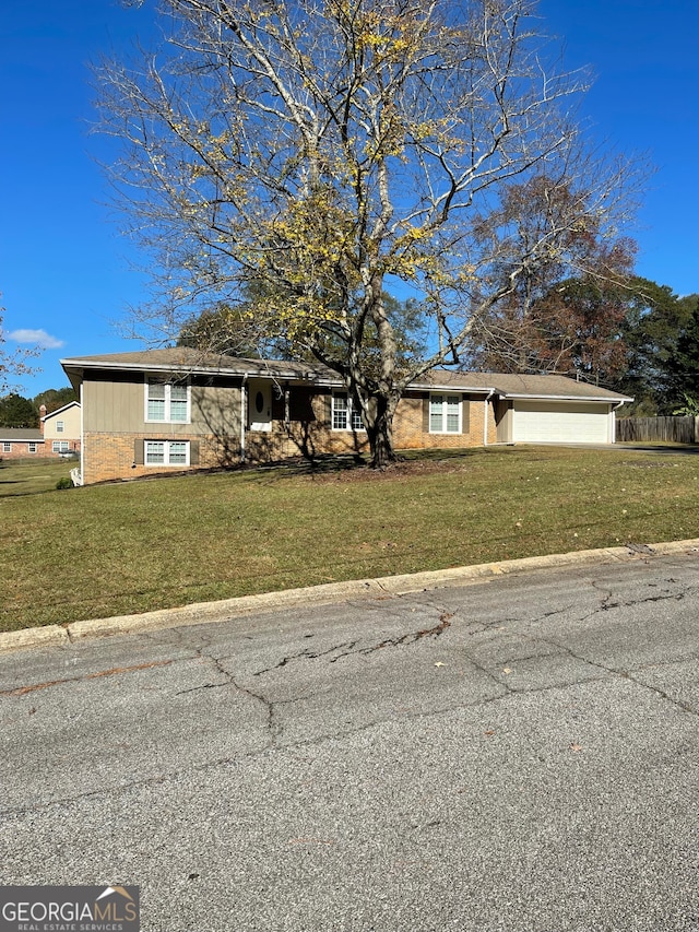 view of front of home featuring a garage and a front yard