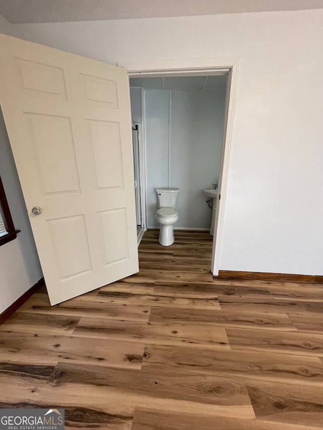 bathroom featuring hardwood / wood-style floors and toilet