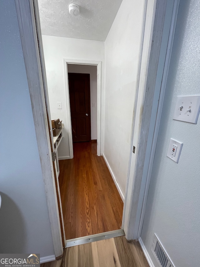 hall with hardwood / wood-style floors