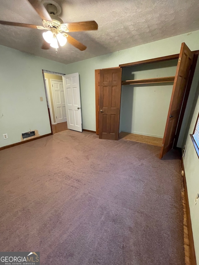 unfurnished bedroom with carpet, a textured ceiling, and ceiling fan