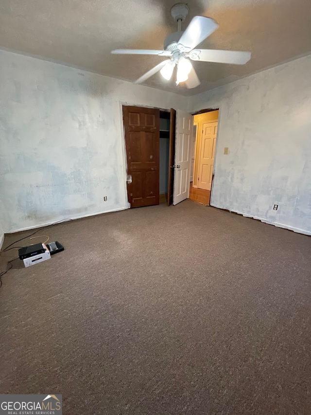 unfurnished bedroom with ceiling fan and carpet