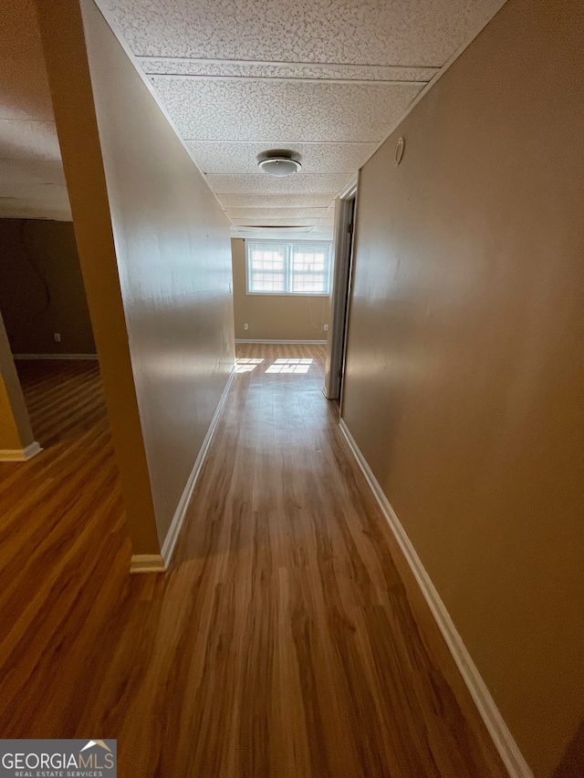 corridor with hardwood / wood-style floors