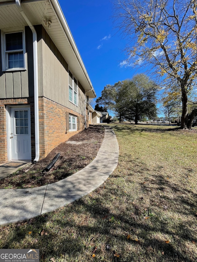 view of home's exterior with a yard