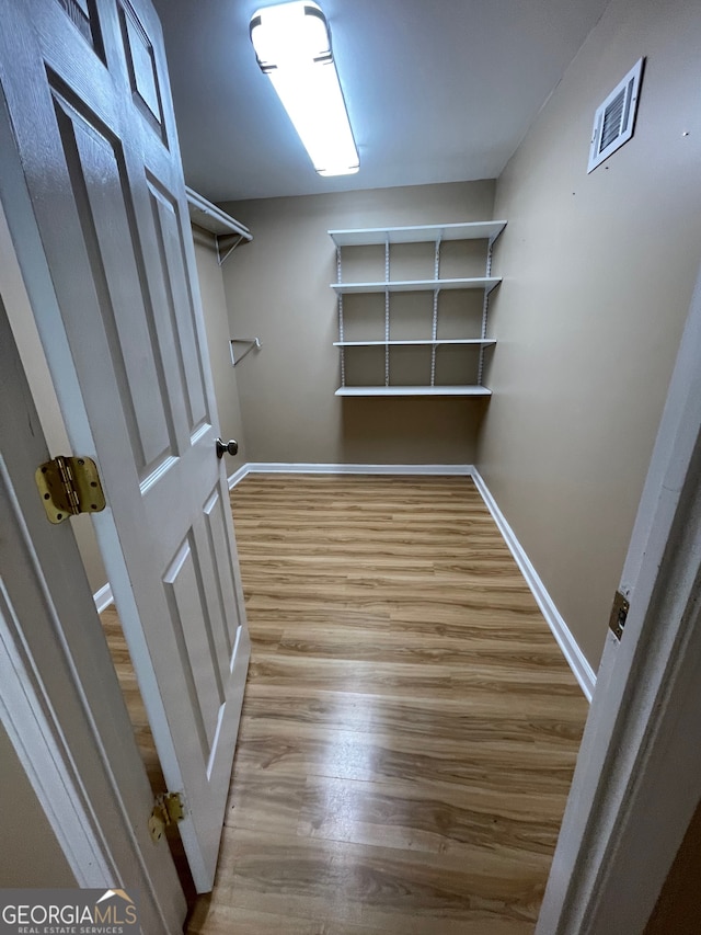 walk in closet featuring hardwood / wood-style flooring