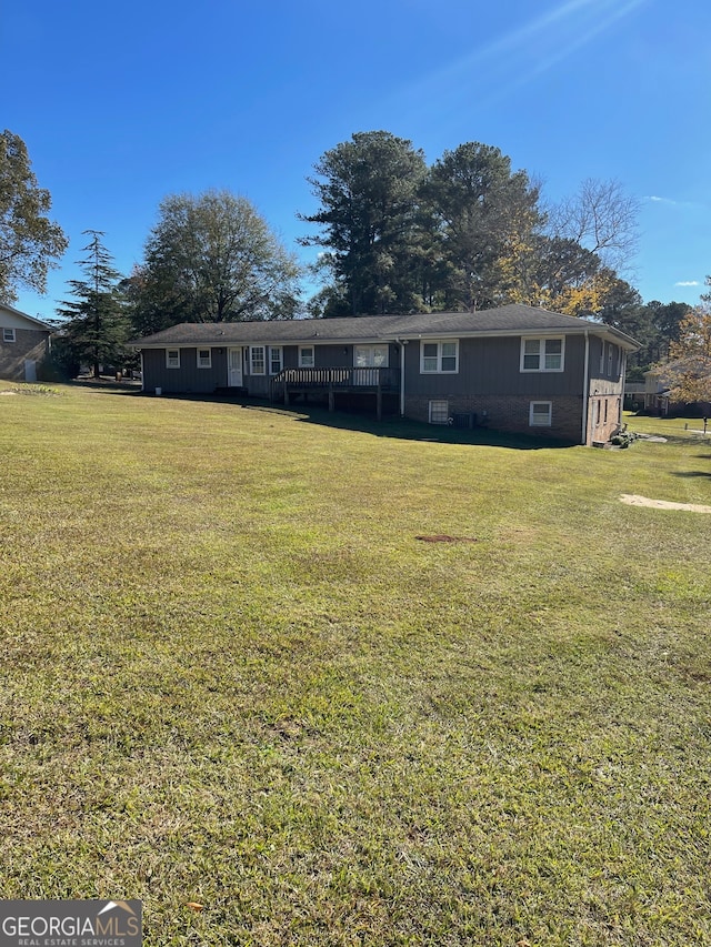 exterior space featuring a lawn and a wooden deck