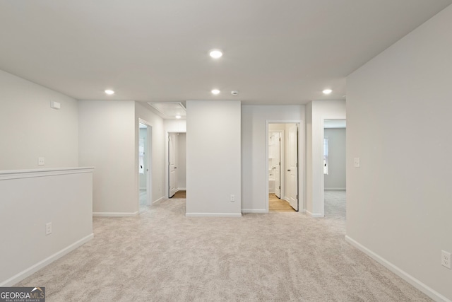 basement with recessed lighting, light colored carpet, and baseboards