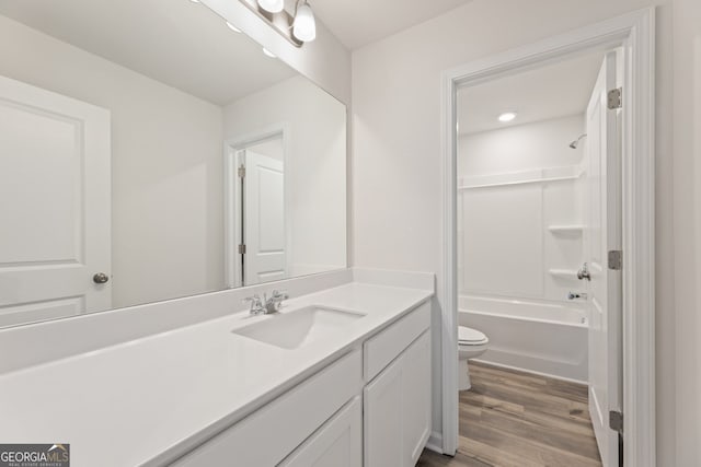 full bathroom featuring tub / shower combination, vanity, toilet, and wood finished floors