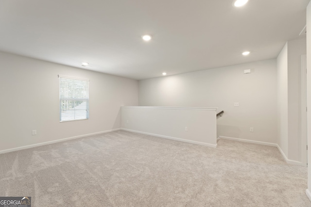 unfurnished room with light carpet, baseboards, and recessed lighting