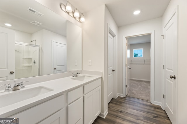 full bath featuring a stall shower, visible vents, and a sink