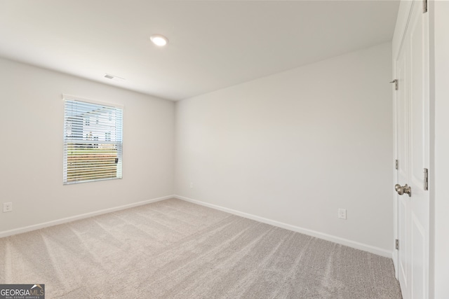 interior space with carpet flooring, visible vents, and baseboards