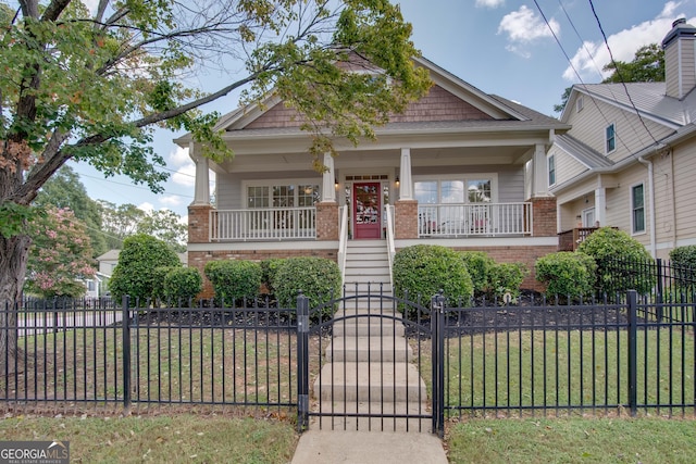 view of front facade featuring covered porch and a front lawn