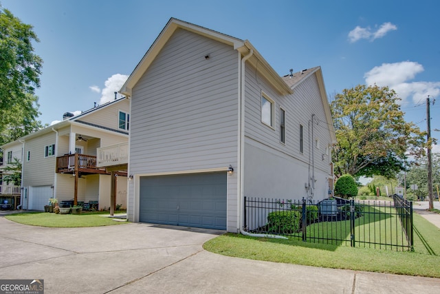 view of property exterior with a balcony, a yard, and a garage