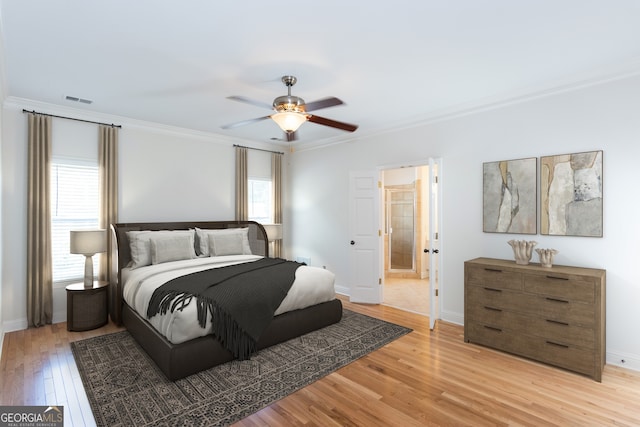 bedroom featuring crown molding, light hardwood / wood-style flooring, and ceiling fan