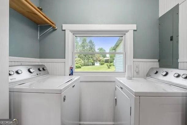 laundry room featuring electric panel and washer and dryer