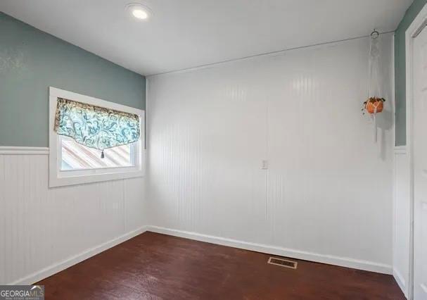 empty room featuring dark wood-type flooring