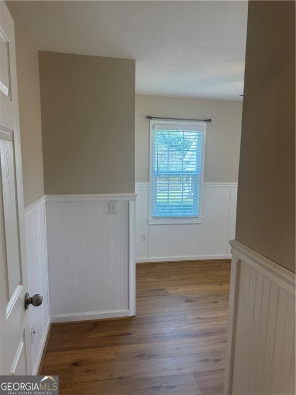 spare room featuring wood-type flooring