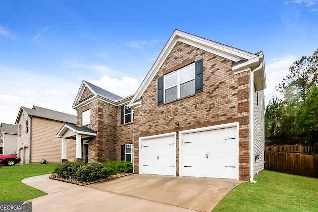 view of front of house featuring a front yard and a garage